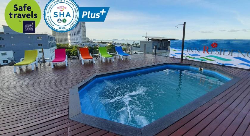 a swimming pool with a pool table and chairs, Inn Residence Serviced Suites (SHA Plus+) in Pattaya