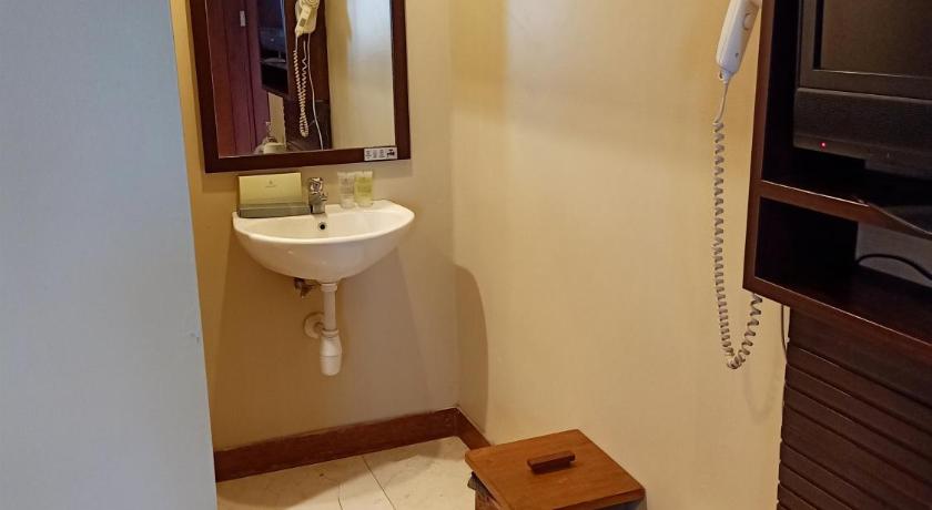 a bathroom with a toilet a sink and a television, Jiwa Jawa Resort Bromo in Bromo