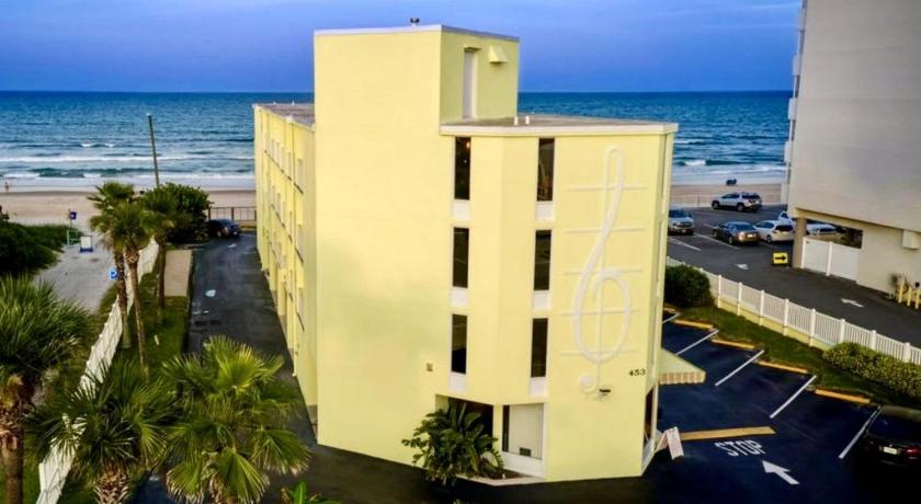 a large white building sitting on top of a beach, Just Beachy -Ocean View at Symphony Beach Club in Ormond Beach (FL)