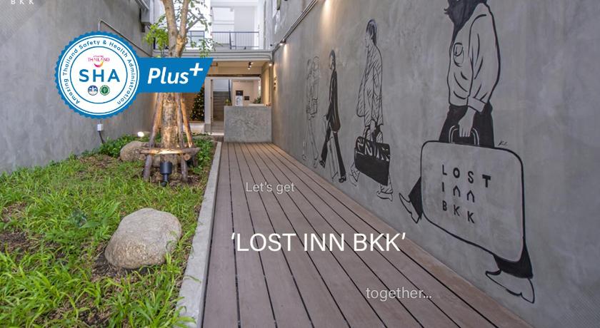 a wall with graffiti on it and a bench with graffiti on it, Lost Inn BKK (SHA Extra Plus) in Bangkok