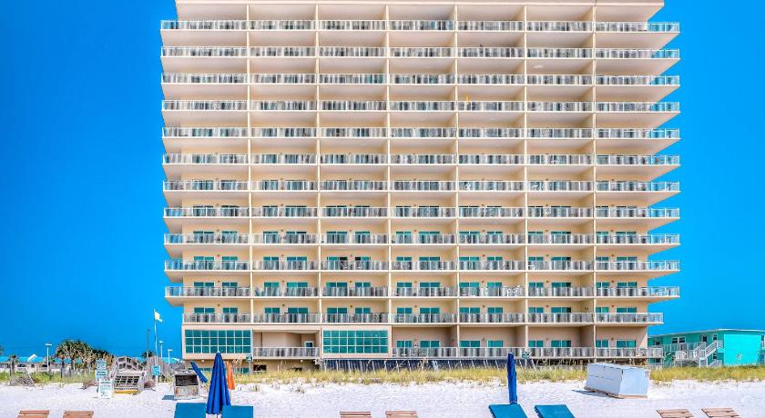 a row of beach chairs sitting on top of a sandy beach, Crystal Shores in Gulf Shores (AL)