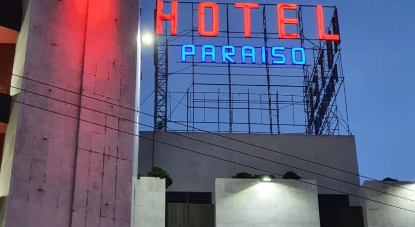 a building with a clock on the front of it, Hotel Paraiso in Mexico City