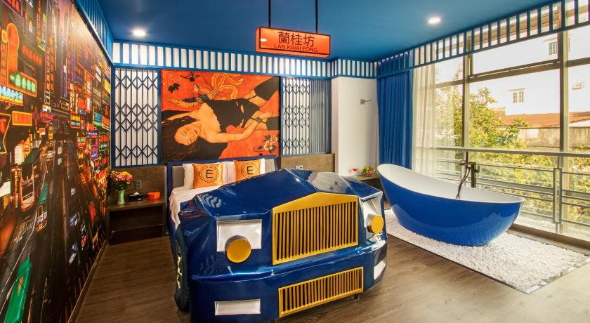 a blue truck parked in a room next to a wall, Eros hotel 2 in Ho Chi Minh City