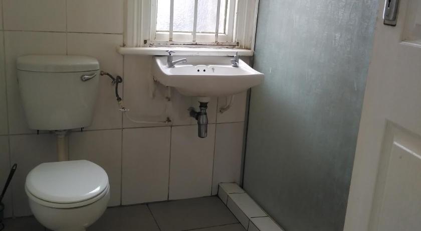 a white toilet sitting in a bathroom next to a window, Lisokhanya GuestHouse in East London