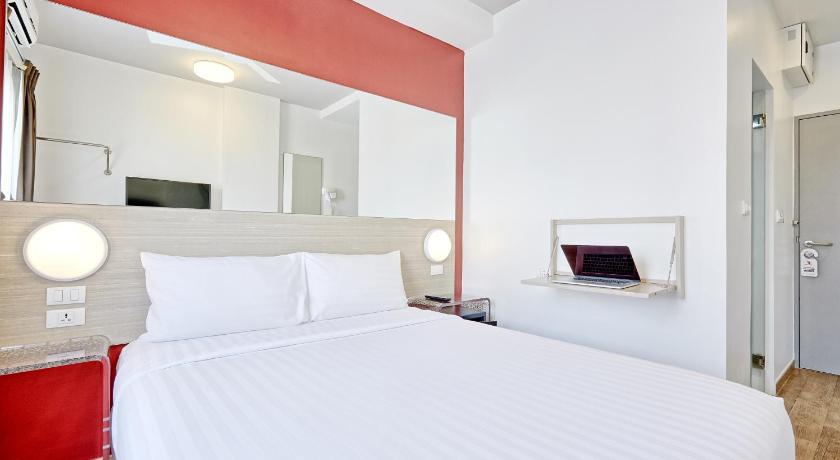 a hotel room with a white bed and white walls, Red Planet Pattaya (SHA Extra Plus) in Pattaya