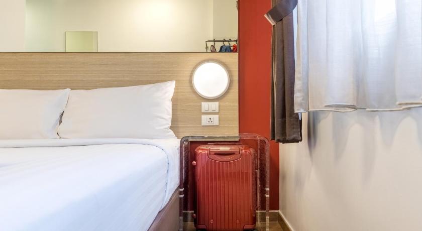 a hotel room with a bed and a chair, Red Planet Pattaya (SHA Extra Plus) in Pattaya