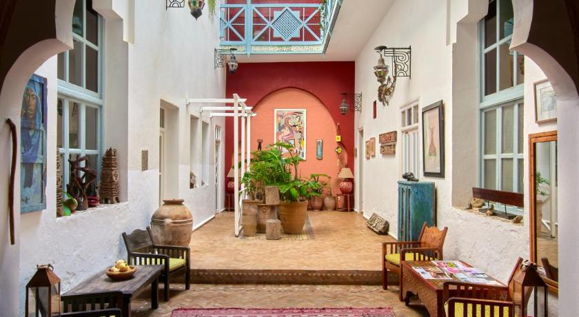 a living room filled with furniture and decor, Ryad Watier in Essaouira