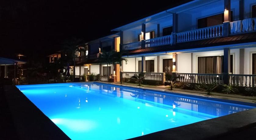 a large swimming pool with a blue sky, Portofino Panglao Bohol in Bohol