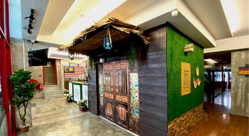 a living room with a wooden floor and a wall with pictures on it, Eman Cottage@KIP Sentral KLIA1 & KLIA2 in Kuala Lumpur