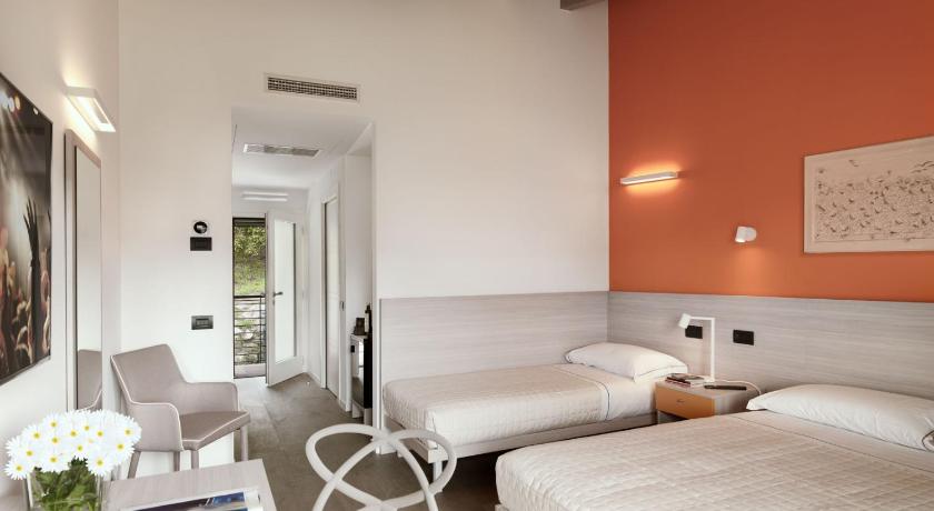 a hotel room with two beds and a desk, Residence Caffe Maya in Maslianico
