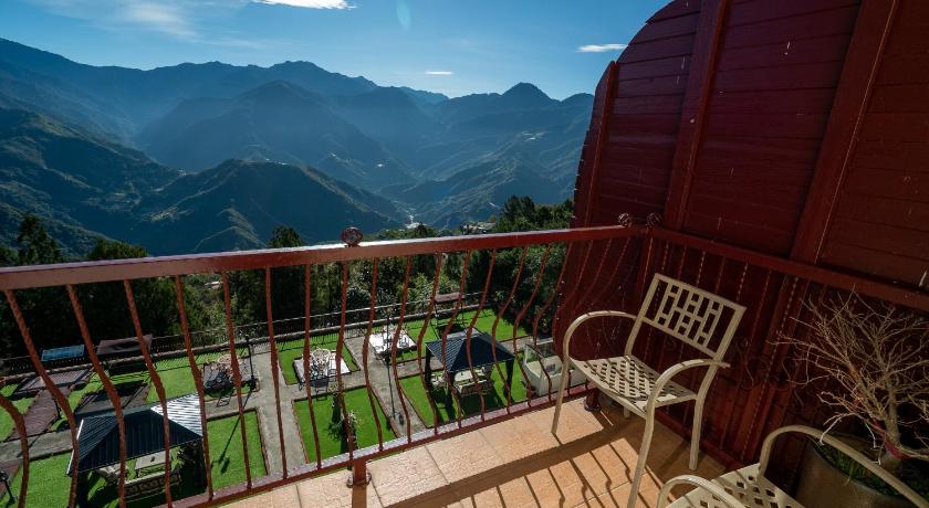 a view from a balcony of a cabin with a view of the mountains, Cingjing Baiyun Resort in Nantou
