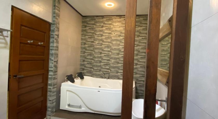 a bathroom with a bed and a shower, RIVER VALLEY HOMESTAY in Kangar