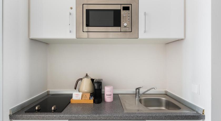 a microwave oven sitting on top of a kitchen counter, numa I Blau Apartments in Frankfurt am Main
