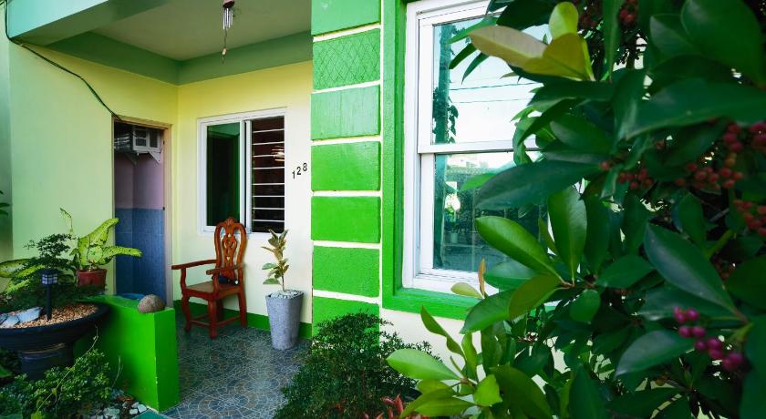 a green patio with a patio door open and a plant growing out of it, RedDoorz D128 Lodge Cagayan Valley in Tuguegarao City