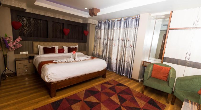 a bedroom with a large bed and a large window, Hotel Marinha Pvt. Ltd. in Kathmandu