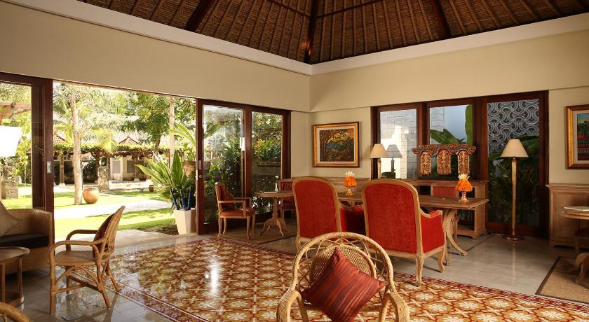 a living room filled with furniture and a large window, Sudamala Suites & Villas in Bali