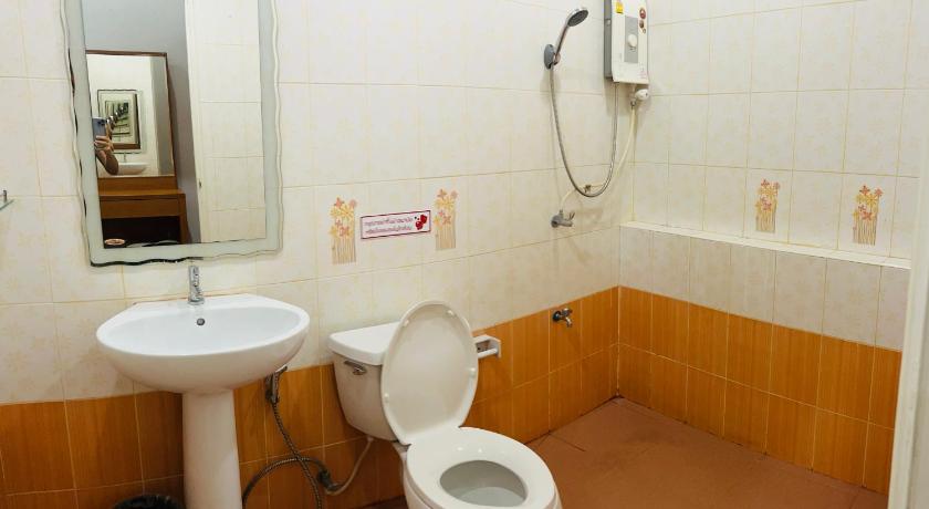 a bathroom with a toilet and a sink, ช้างเผือกเกสต์เฮ้าส์ in Nan
