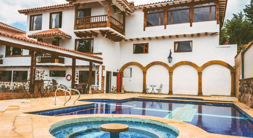 a large swimming pool in front of a house, Casa de Campo Hotel & Spa in Villa De Leyva