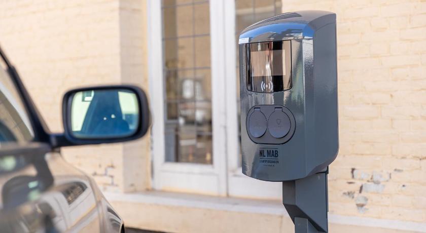 a parking meter in front of a car, Atlas Hotel in Valkenburg