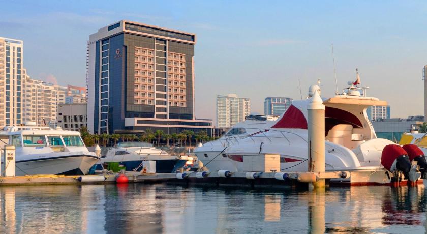 a large white boat docked in a marina, The Grove Hotel & Conference Centre Bahrain in Manama