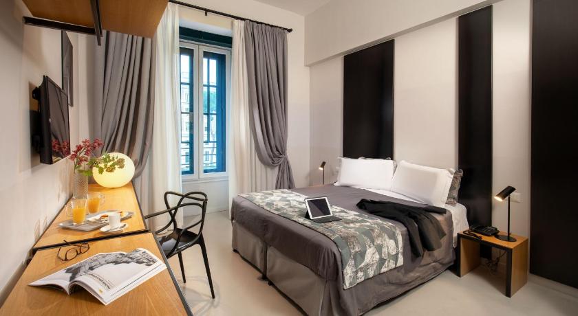 a bedroom with a bed and a desk, Viminale View Hotel in Rome