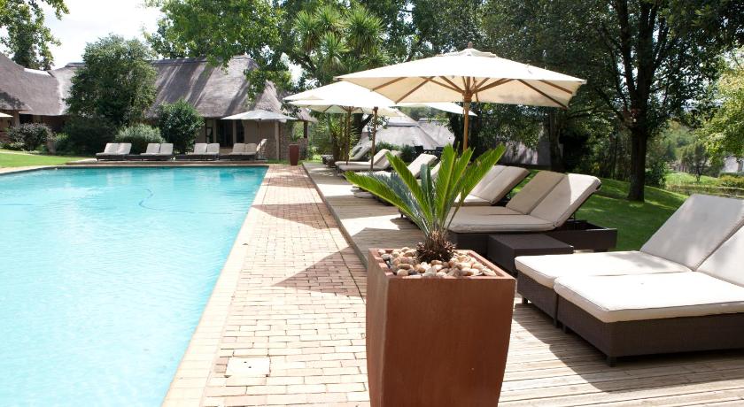 a garden area with a patio table and chairs, Valley Lodge and Spa in Magaliesburg