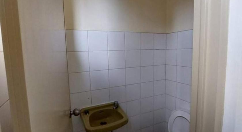 a bathroom with a toilet and a sink in it, OYO 840 Orangenest Apartelle in Manila