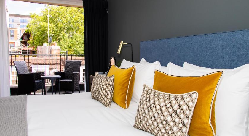 a large bed with pillows and pillows on top of it, Native Mayfair in London