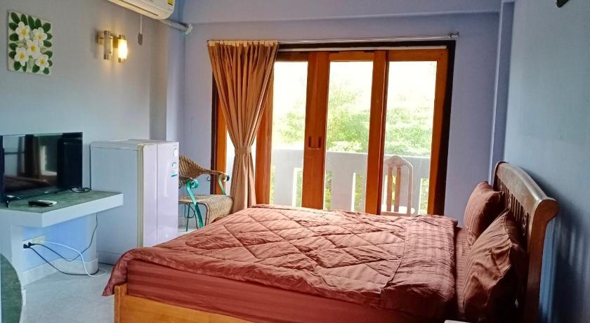 a bedroom with a large bed and a large window, Pott Guesthouse in Koh Samui