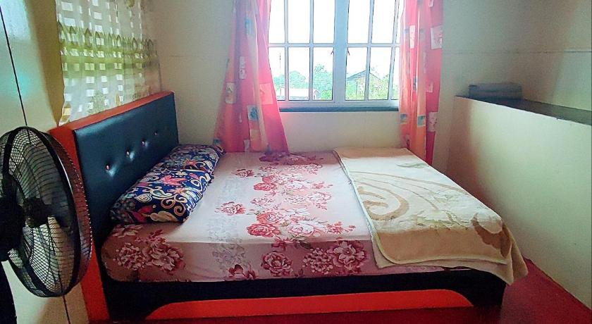 a bedroom with a bed and a window, Kinabalu Valley Guesthouse in Kinabalu National Park