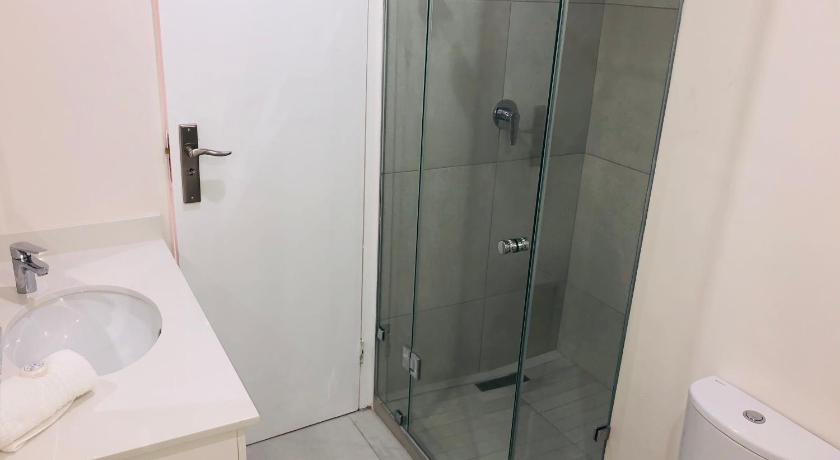 a bathroom with a shower stall and a toilet, 22 Kyalanga Beachfront Apartment in Durban