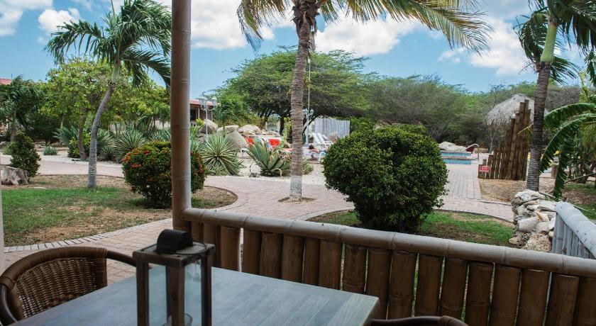 a patio area with a patio table and chairs, Camacuri Apartments in Oranjestad
