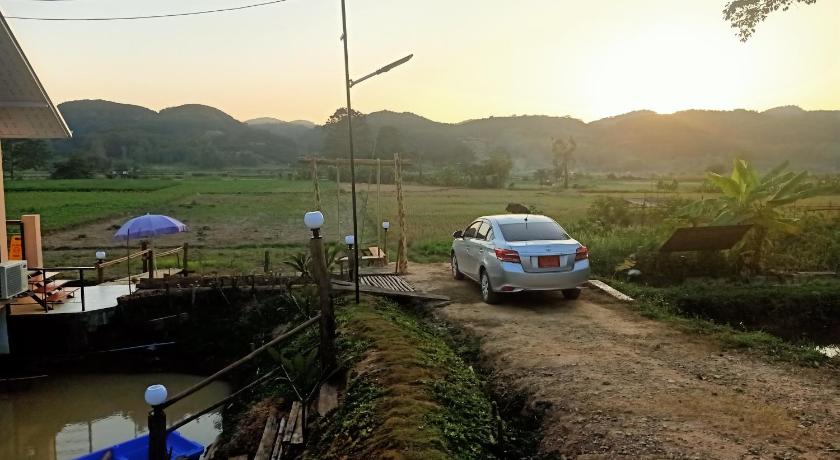 a car parked on the side of a road next to a body of water, Nan De Villa in Nan