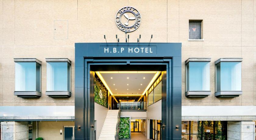 a building with a clock on the front of it, H.B.P HOTEL in Osaka