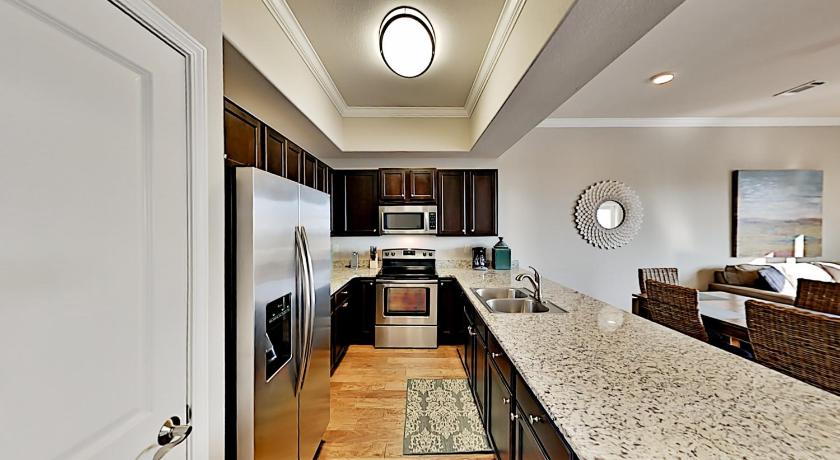 a kitchen with a refrigerator, stove, sink and cabinets, Alerio Condos in Destin (FL)