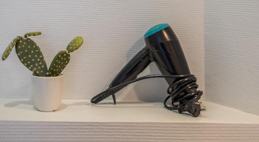 a hair dryer is sitting on top of a counter, Apartment WS Louvre - Etienne Marcel in Paris