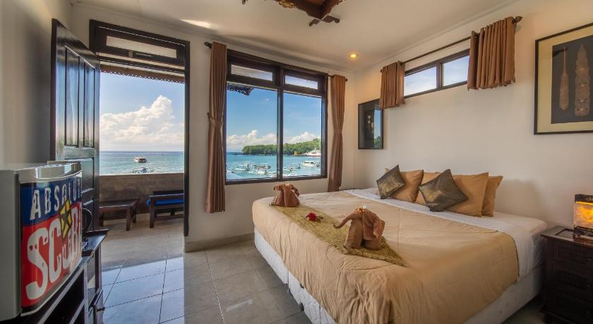 a bedroom with a large bed and a large window, Absolute Scuba Bali Dive Resort in Bali