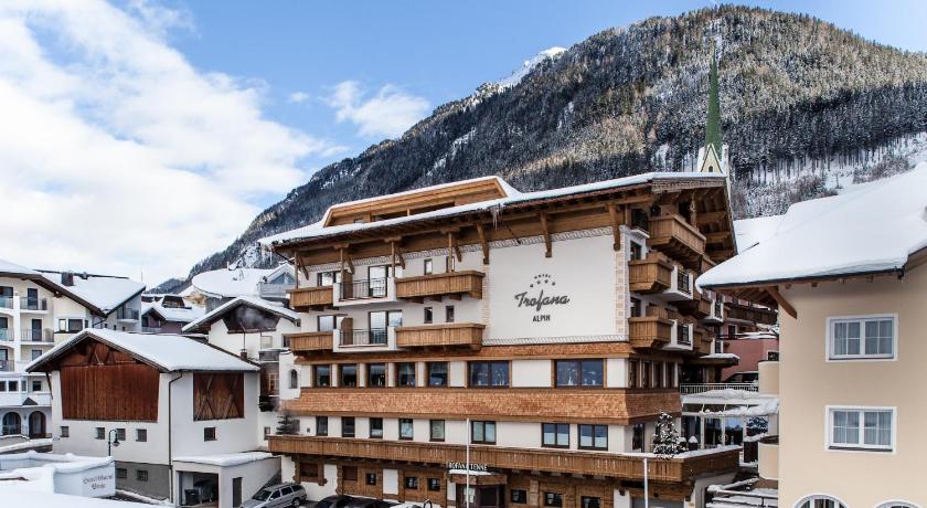 a large building with a ski lift on top of it, Hotel Trofana Alpin in Ischgl