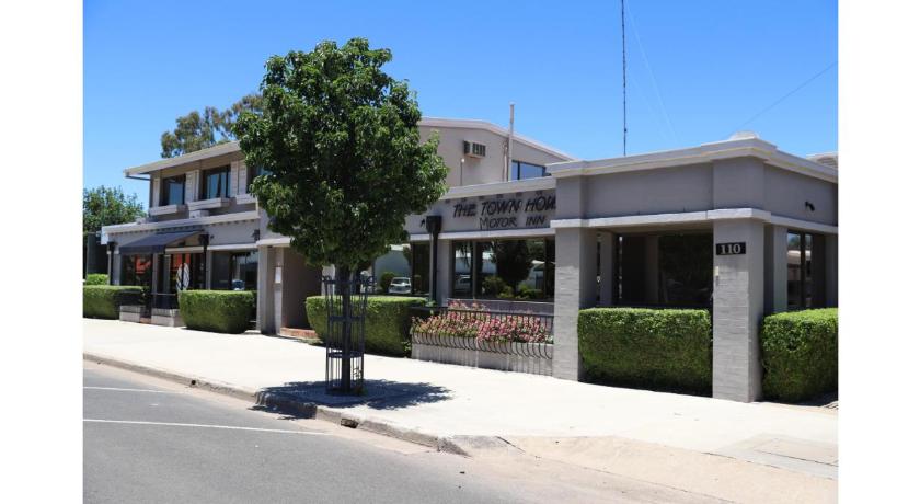 a large white building with a tree in front of it, The Town House Motor Inn in Goondiwindi