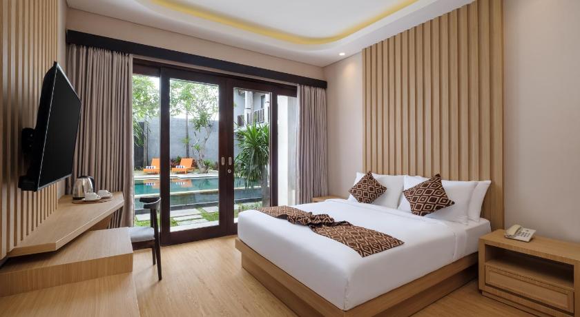 a bedroom with a large bed and a large window, ABISHA Hotel Sanur in Bali