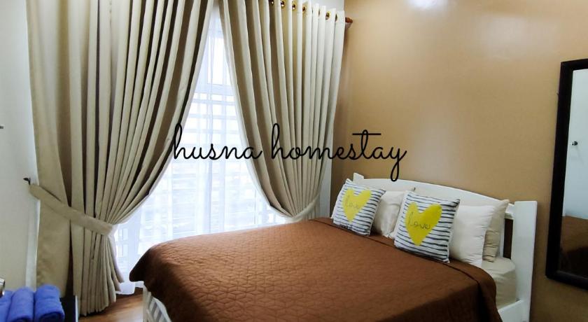 a bedroom with a large bed and a large window, Husna Apartment DPerdana Kota Bharu in Kota Bharu