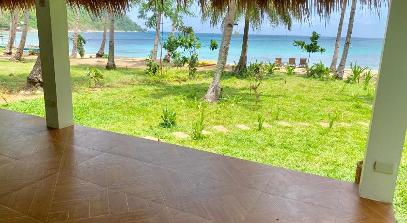 a patio area with a patio table and chairs, Moon Beach Villas El Nido in Palawan