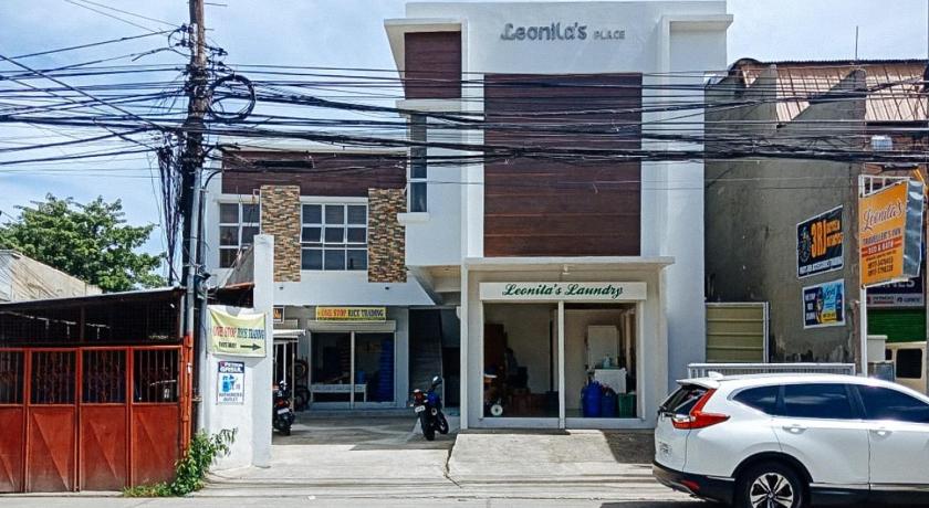 a white car parked in front of a building, Leonila's Travellers Inn in Iloilo