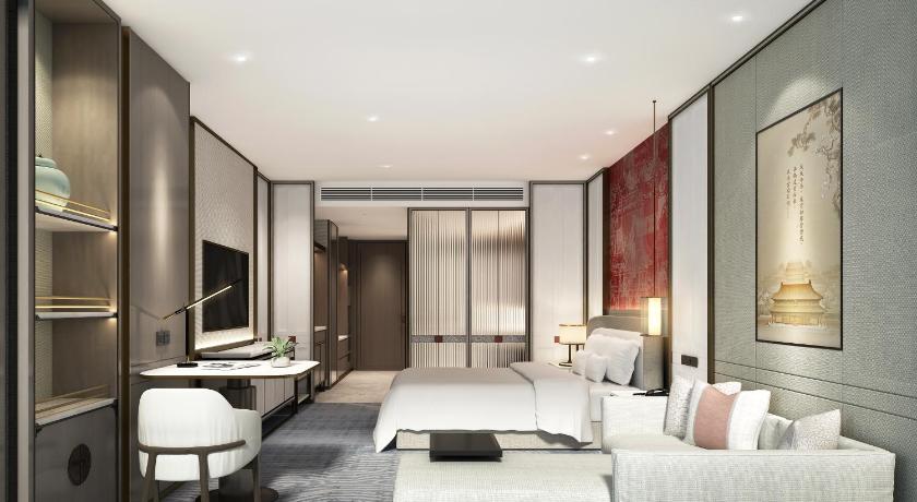 a living room filled with furniture and a large window, Grand MetroPark Yuantong Hotel in Beijing