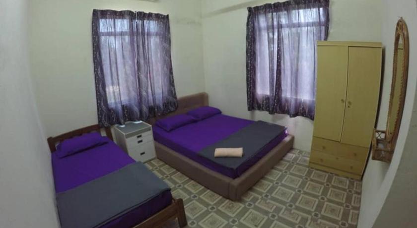 a hotel room with two beds and two windows, Homestay Tok Abah Kuala Besut in Besut