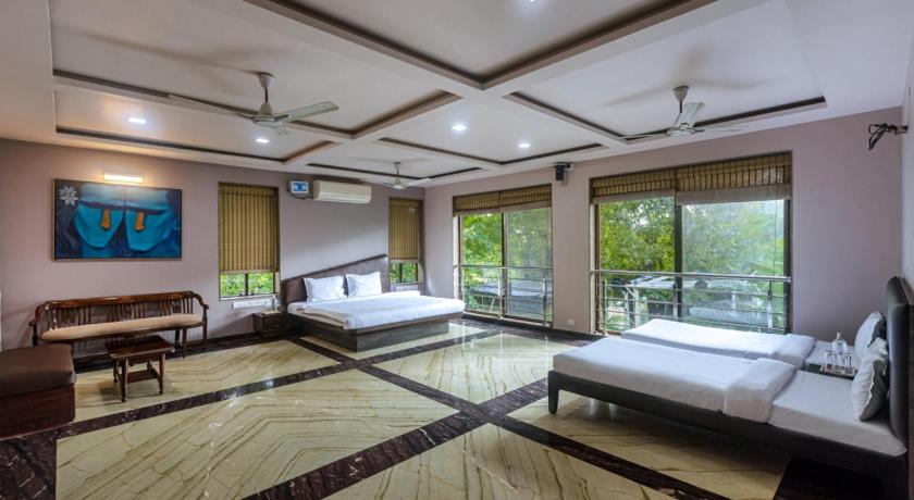 SaffronStays Aura, Alibaug - luxury pool villa with a game room and spacious lawn photo