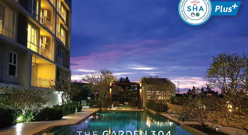 a large swimming pool in front of a large building, The Garden 304 (SHA Extra Plus) in Prachinburi