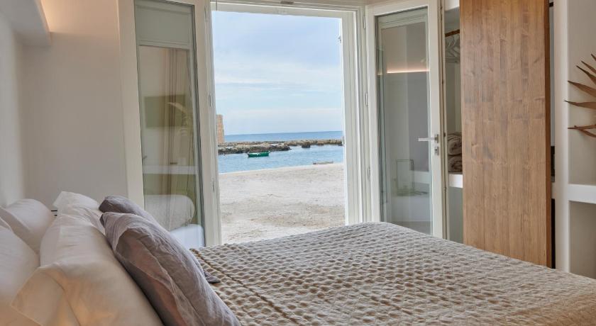 a hotel room with a bed and a window, Musae al Mare in Polignano a Mare