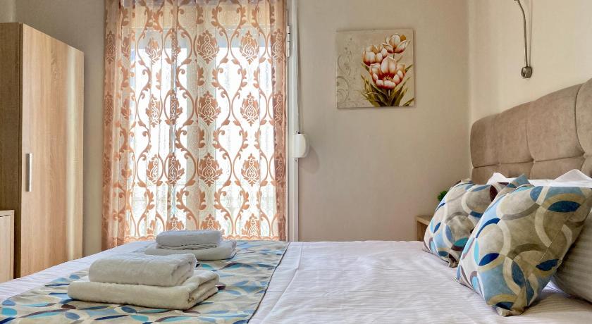 a bedroom with a bed and a window, Pelineon Rooms in Chios