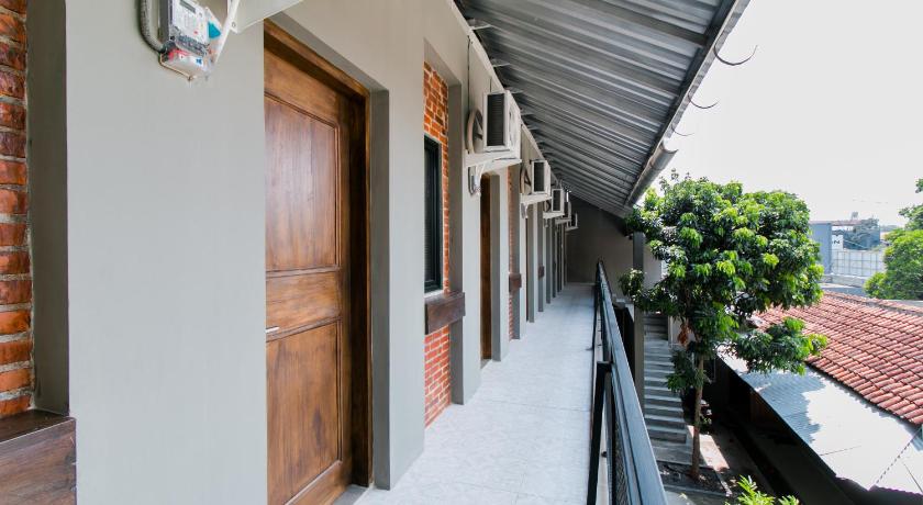 a building that has a patio door open, Super OYO Collection O 1898 Louise Place in Puncak